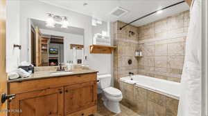 Full bathroom with vanity, toilet, and shower / bath combo with shower curtain