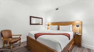 Bedroom featuring dark wood-type flooring