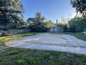 View of pool with a lawn