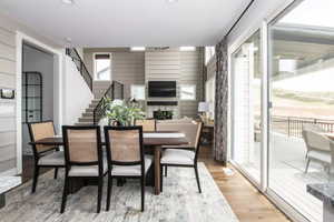 Dining room featuring wooden walls and light hardwood / wood-style floors. *Photos are of our Stella model home.  Actual colors and finishes will vary.  See agent for additional information.