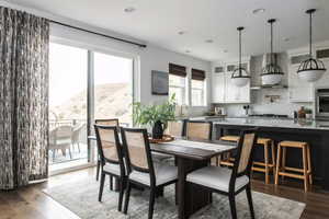 Dining space with dark wood-type flooring, a mountain view, and sink. *Photos are of our Stella model home.  Actual colors and finishes will vary.  See agent for additional information.