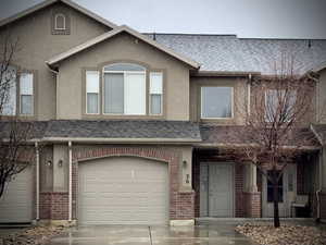 Townhome / multi-family property featuring a garage