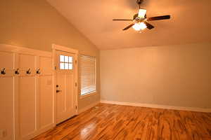 Foyer featuring vaulted ceiling, ceiling fan, and light hardwood / wood-style floors