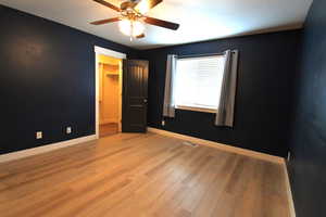 Empty room featuring light hardwood / wood-style flooring and ceiling fan