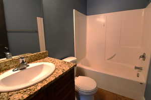 Full bathroom featuring shower / bathing tub combination, vanity, and toilet