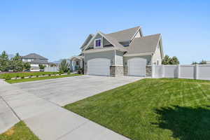 View of front of house featuring a garage and a front lawn