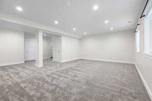 Basement featuring light carpet