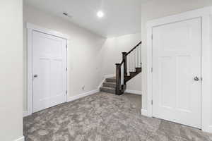 Entrance foyer featuring carpet floors