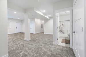 Basement featuring light carpet