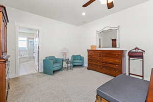 Sitting room featuring light carpet and ceiling fan