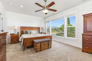 Primary Bedroom featuring ceiling fan, a mountain view, and light carpet