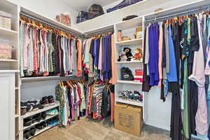 Primary Walk in closet with carpet floors