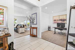 Interior space with light carpet and french doors