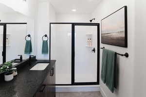 Bathroom featuring vanity and an enclosed shower