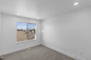 Bedroom 3 with light colored carpet and a closet