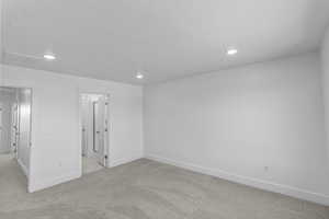 Primary Bedroom with light colored carpet