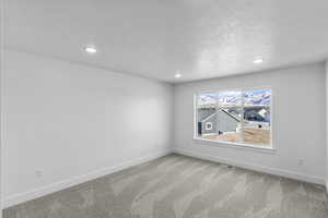 Primary Bedroom with light colored carpet