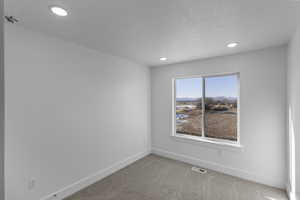 Bedroom 3 with light colored carpet and a closet