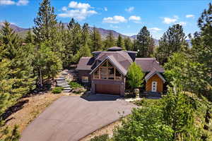 View of front of property with a garage and a mountain view