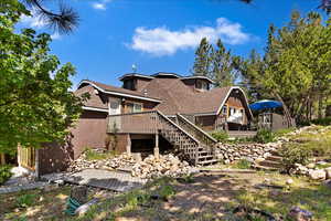 Rear view of property featuring a wooden deck