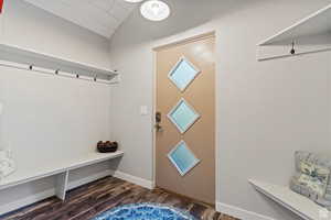 Mudroom featuring lofted ceiling and dark hardwood / wood-style floors