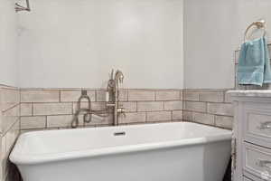 Bathroom with vanity and a bathtub