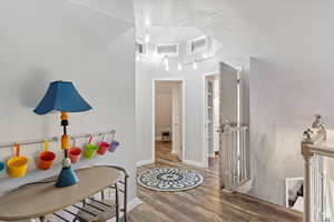 Hall featuring hardwood / wood-style floors and a textured ceiling