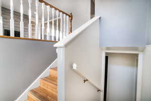 Stairs featuring hardwood / wood-style floors