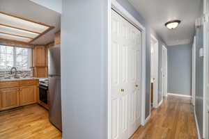 Hall featuring sink and light hardwood / wood-style flooring