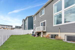 Rear view of property with a yard