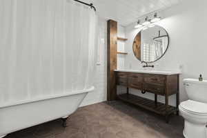 Bathroom featuring vanity, claw foot tub