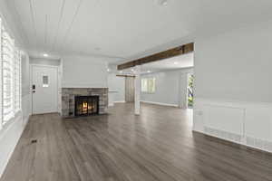 Living room wood flooring, stone fireplace,  shiplap and beamed ceilings