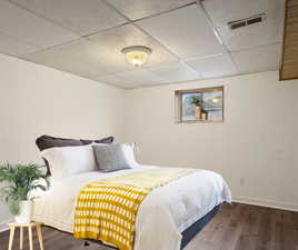 Virtually staged bedroom featuring wood-type flooring.