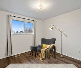 Virtually staged bedroom with wood-type flooring.