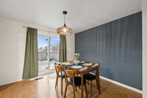 Dining room featuring wood-type flooring.