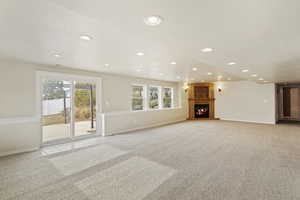 Unfurnished living room featuring light colored carpet