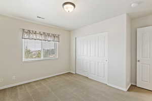 Unfurnished bedroom with a closet and carpet