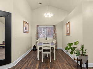 Dining room with chandelier, and laminate flooring