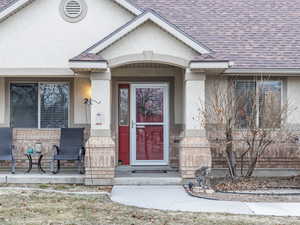 Entrance to property with covered porch and seating area