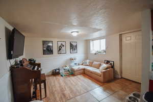 Tiled living room with a textured ceiling