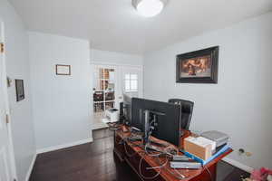 Office space featuring dark wood-type flooring