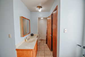 Bathroom with tile patterned flooring, vanity, and toilet