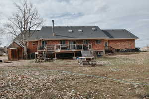 Rear view of house featuring a wooden deck