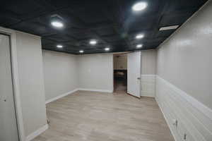 Basement with light wood-type flooring