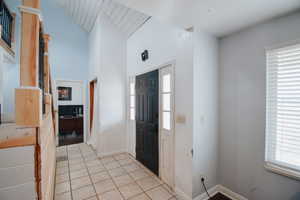 Foyer entrance with light tile patterned floors