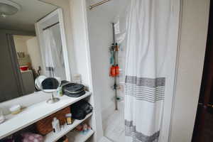 Bathroom featuring tile patterned floors and washer / dryer