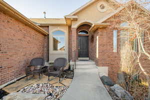 View of exterior entry featuring a patio