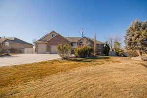 Ranch-style house with a garage and a front yard