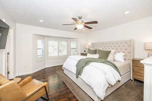 Bedroom with ceiling fan and dark hardwood / wood-style flooring