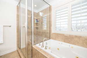 Bathroom featuring ornamental molding, tile patterned floors, and shower with separate bathtub